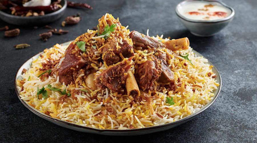 Aromatic mutton biryani made with basmati rice, slow-cooked lamb, and traditional spices.