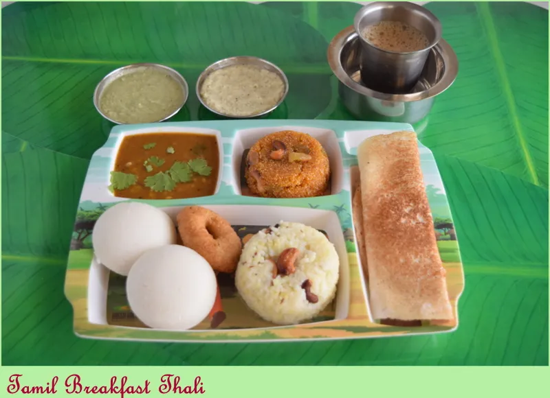 Mini tiffin meal featuring idli, mini dosa, vada, sambar, and coconut chutney served on a plate.